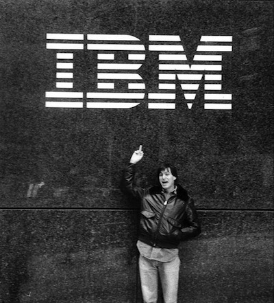 Steve Jobs pictured under IBM logo