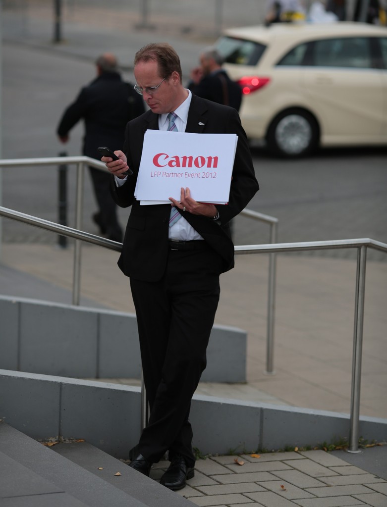 Canon man waits at Photokina